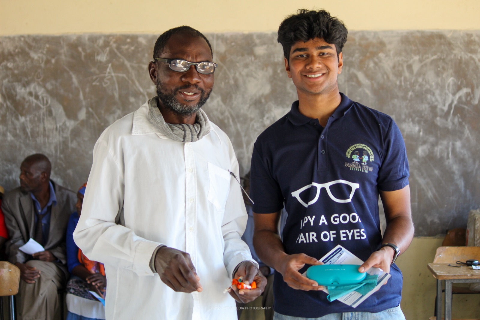 The man receiving his new glasses from our team